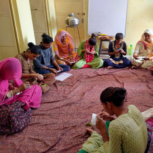 Indian women sewing coasters