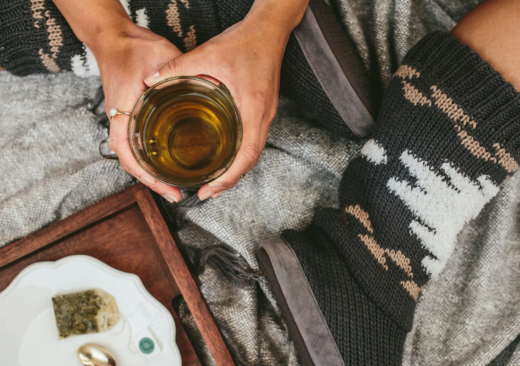 Woman holding steeping cup of tea