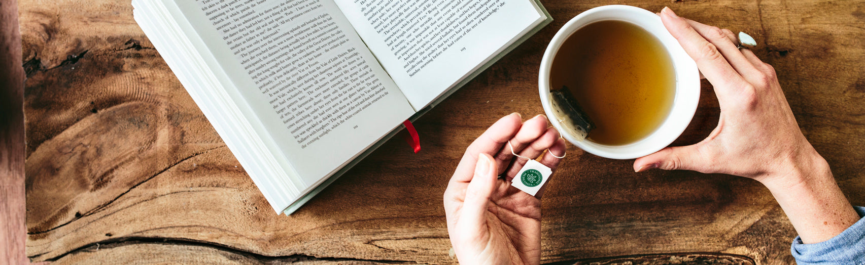 Person enjoying tea while reading