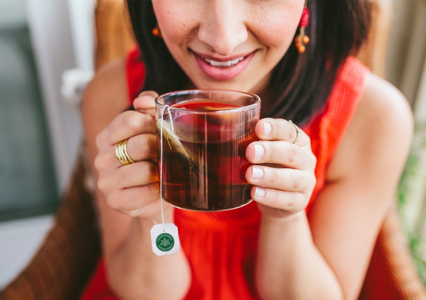 Organic Dandelion Leaf & Root Tea in Glass Mug held in Hands